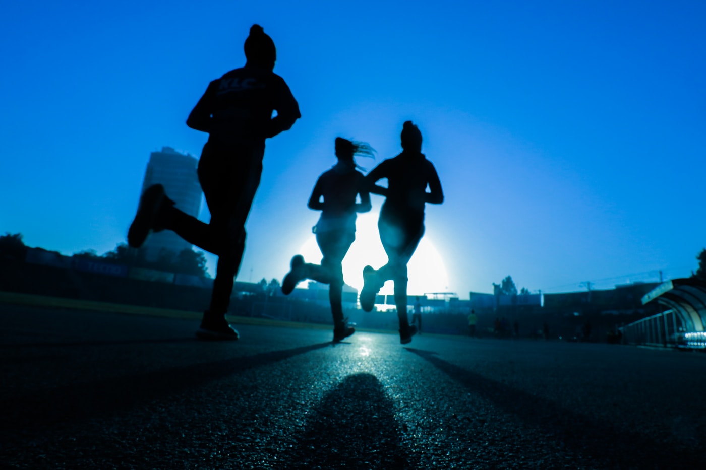Runners training outdoors in early morning light
